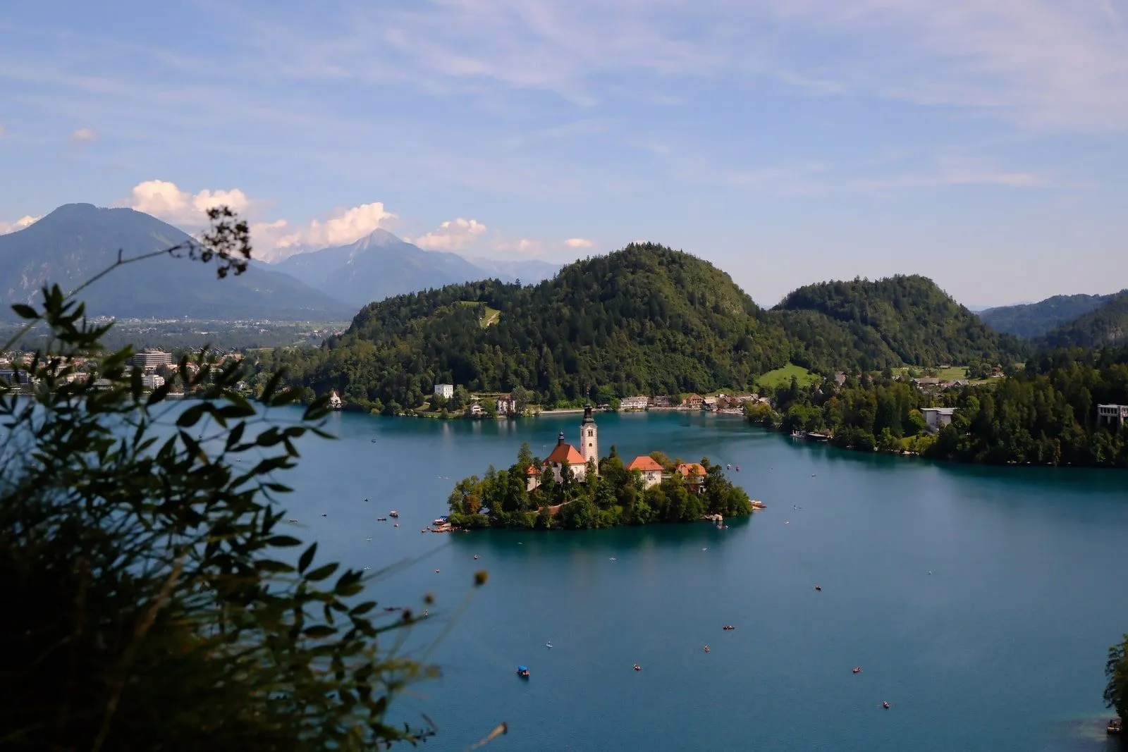 Lake Bled's island church seen from a high vantage point, ringed by mountains.