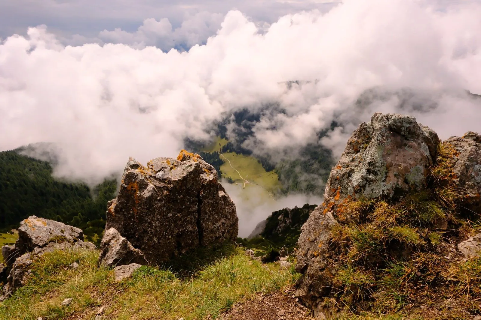 A rocky alpine ridge breaking through low cloud in the Julian Alps.